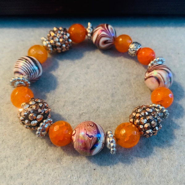 Brown and orange beaded stretch bracelet with alternating orange and sparkly brown beads