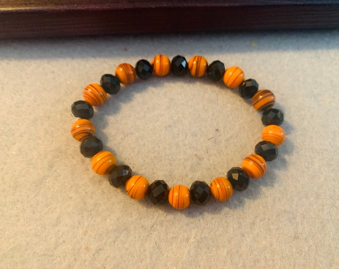 Halloween beaded stretch bracelet with orange & black , alternating black beads