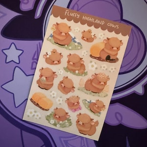 May include: A sheet of stickers featuring cartoon Highland cows in various poses. The stickers are primarily shades of brown and tan, with green grass and white flower accents. The text "Fluffy Highland Cows" is printed at the top.