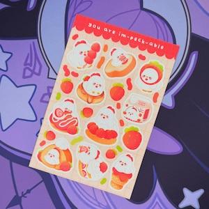 May include: A sheet of stickers with a grid pattern. The stickers feature cartoon chickens with various desserts, including strawberries and ice cream. The text "you are im-peck-able" is at the top of the sheet.