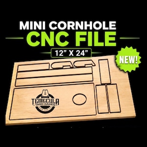 May include: A light-colored wooden board featuring laser-cut outlines for a mini cornhole game, including a board with a circular hole and the Temecula Yard Games logo. The text reads MINI CORNHOLE CNC FILE 12" X 24" and NEW! on a black background.