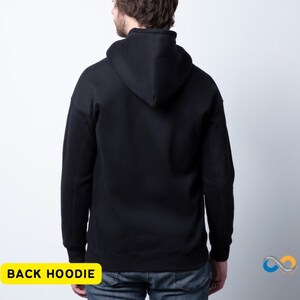 May include: A black hoodie, viewed from the back, with a hood and long sleeves. The hoodie is a solid black color. The text "BACK HOODIE" is in a yellow rectangle at the bottom of the image.