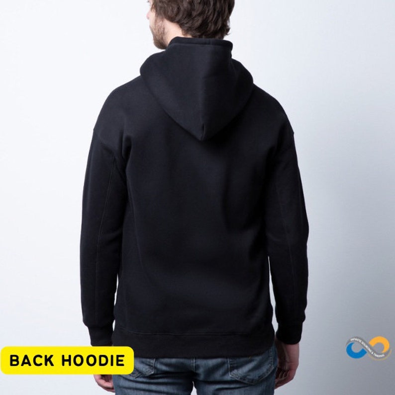 May include: A black hoodie, viewed from the back, with a hood and long sleeves. The hoodie is a solid black color. The text "BACK HOODIE" is in a yellow rectangle at the bottom of the image.
