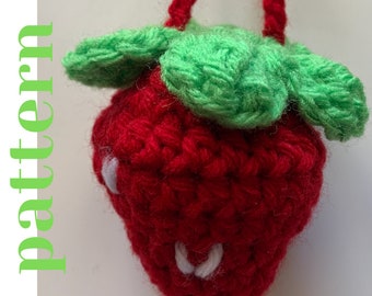 May include: A crocheted strawberry with green leaves and white embroidered details. The strawberry is red and has a textured surface.