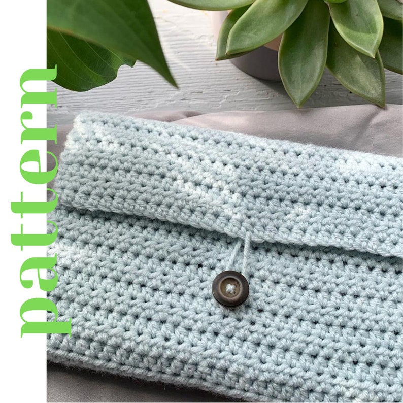 May include: A light blue crocheted clutch with a button closure and a loop for a strap. The clutch is made with a simple stitch pattern.