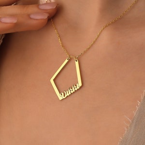 May include: A gold necklace with a diamond-shaped pendant that says "Vikki" in cursive.
