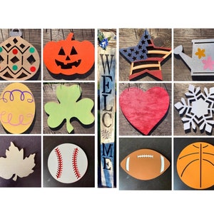 May include: A collection of wooden seasonal and holiday-themed cutouts. Includes a pumpkin, star, heart, snowflake, maple leaf, baseball, football, and basketball. Also includes a welcome sign.