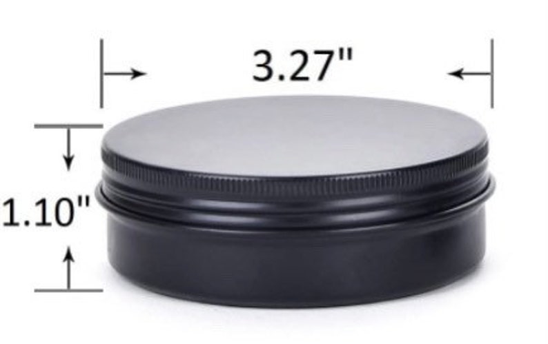 May include: A black metal tin with a silver lid. The tin measures 3.27 inches in diameter and 1.10 inches in height. The lid is flat and the sides of the tin are ridged.