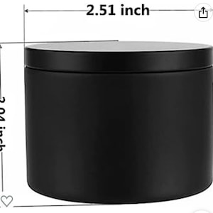 Pu&ograve; includere: Un barattolo cilindrico in metallo nero opaco con coperchio. Il contenitore presenta linee di dimensione stampate che indicano un diametro di 6,38 cm e un'altezza di 5,18 cm. L'oggetto ha una superficie liscia a tinta unita e un design semplice.