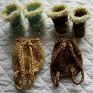 May include: Two pairs of knitted baby booties with white fur trim. One pair is light blue and the other is brown. Two knitted baby backpacks, one is brown and the other is beige.