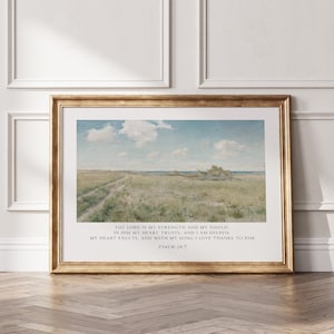May include: A framed landscape print featuring a grassy field under a blue sky with white clouds. Below the image, the text reads: THE LORD IS MY STRENGTH AND MY SHIELD: IN HIM MY HEART TRUSTS, AND I AM HELPED; MY HEART EXULTS, AND WITH MY SONG I GIVE THANKS TO HIM. PSALM 28:7.