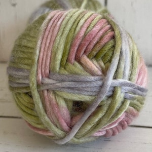 May include: A ball of yarn with green, pink, and gray stripes. The yarn is soft and fluffy, and it would be perfect for knitting or crocheting.