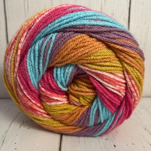 May include: A ball of colorful yarn with stripes of pink, orange, yellow, blue, and purple.