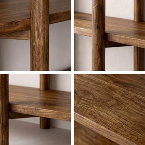 May include: Close-up of a wooden bookshelf with multiple shelves. The wood has a warm, brown tone with visible grain. The design features vertical supports and horizontal shelves, creating a sturdy and functional storage unit. The finish appears smooth and well-crafted.
