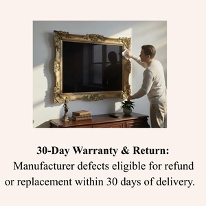 May include: A large television screen mounted on a wall, encased in an ornate, gold-coloured rectangular frame with intricate carved detailing. The screen displays a dark, reflective surface. Below the television sits a dark wooden console table.