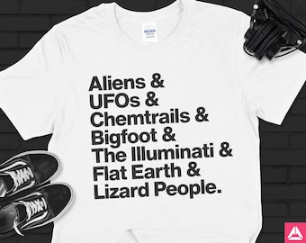 May include: White t-shirt with black text that reads "Aliens & UFOs & Chemtrails & Bigfoot & The Illuminati & Flat Earth & Lizard People."