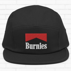 May include: Black 5-panel hat with a red and white logo that says "Burnies".