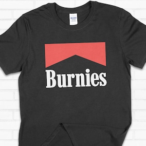 May include: Black t-shirt with a red and white logo that says "Burnies" in a white sans-serif font.