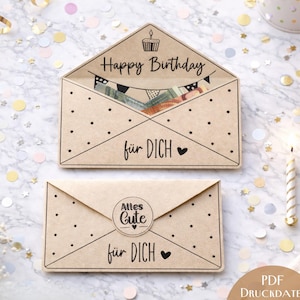 May include: Two kraft paper birthday cards. One is open, revealing money and a banner, with the text "Happy Birthday" and "für DICH". The other card is closed, with the text "Alles Gute" and "für DICH".