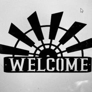 May include: Black metal welcome sign with a windmill design. The sign says "WELCOME" in white letters.