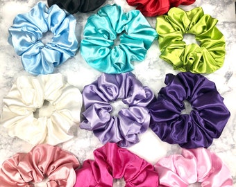 May include: A set of 12 colorful satin scrunchies in various colors, including black, red, light blue, turquoise, green, white, lavender, purple, pink, and magenta.