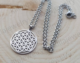 May include: A silver necklace with a round pendant featuring a geometric flower of life design. The necklace is made of stainless steel and has a lobster clasp closure.