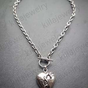 Broken/stitched heart pendant necklace with t bar clasp