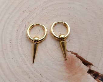 May include: A pair of gold hoop earrings with a pointed spike hanging from each hoop.