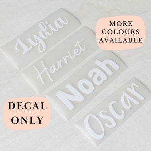 May include: Four rectangular adhesive vinyl decals featuring the white names Lydia, Harriet, Noah, and Oscar in various fonts. The decals are on a translucent backing. Text on the image reads MORE COLOURS AVAILABLE and DECAL ONLY.