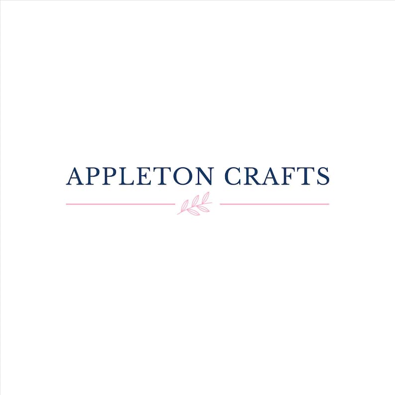 May include: A logo featuring the text APPLETON CRAFTS in dark blue capital letters. Below the text is a thin horizontal pink line interrupted in the center by a small, delicate pink line drawing of a leafy branch with three leaves.