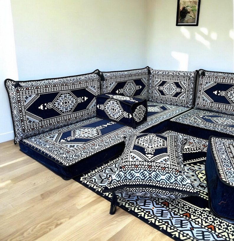May include: A blue and white patterned floor seating set with a corner sofa, cushions, and a rug. The set is arranged in a traditional Moroccan style.