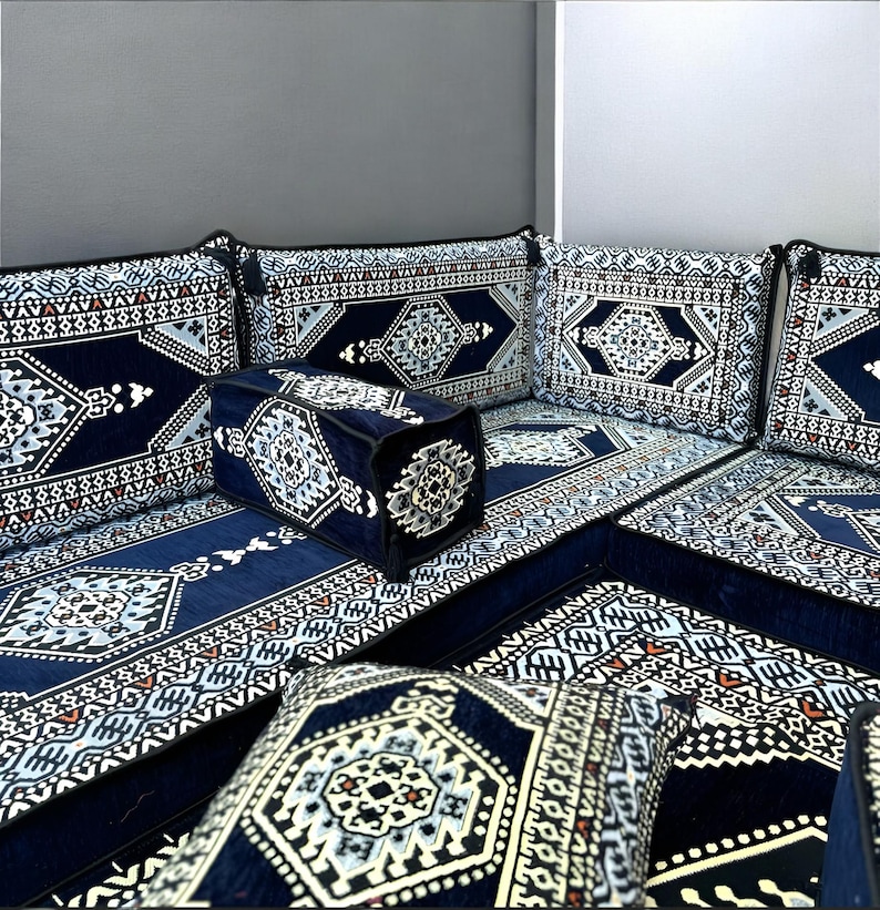 May include: A blue and white patterned floor seating set with cushions. The set includes a large couch, two armrests, and several smaller cushions. The fabric is a soft, plush velvet.
