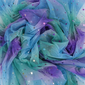 May include: A close-up of iridescent blue, green, and purple tulle fabric with scattered silver and purple glitter stars.