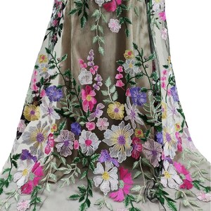 以下が含まれることがあります： ピンク、パープル、イエロー、ホワイトの刺繍された花柄が施されたシアーな生地。花は黒いメッシュの背景にランダムなパターンで配置されています。