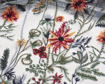 May include: White sheer fabric with embroidered floral designs in shades of red, orange, yellow, green, and black.