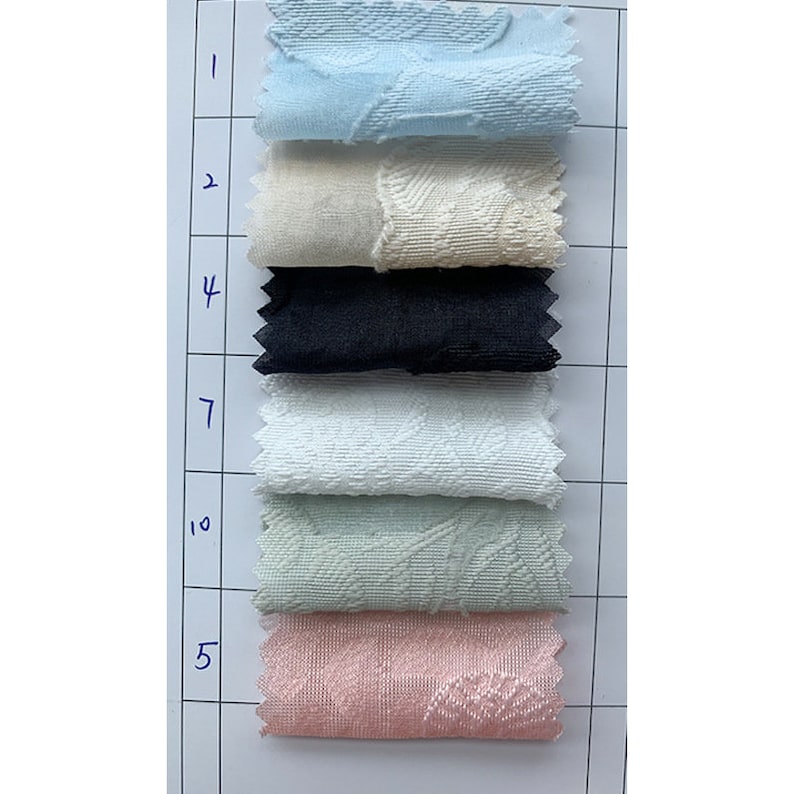 May include: A swatch card with fabric samples in various colors and textures. The swatches are labeled with numbers 1, 2, 4, 7, 10, and 5.