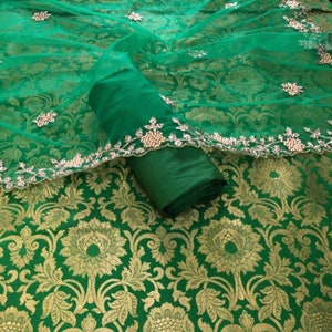 Dress material in Katan Silk Woven Fabric with taffeta silk bottom along net embroidery dupatta.