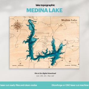May include: A laser-cut wooden map of Medina Lake in Texas, USA. The lake is shown in blue, with surrounding land in brown. The map includes a compass rose, latitude and longitude coordinates, and the text "Medina Lake, Texas, USA".