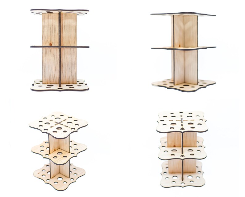 May include: A three-tiered wooden stand with a decorative, scalloped edge and multiple holes for holding items. The stand is made of light-colored wood and is perfect for organizing and displaying small items.