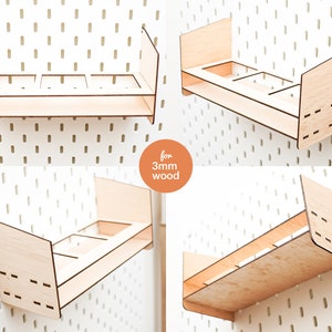 May include: Three wooden shelves with three compartments each, designed for pegboard walls. The shelves are made for 3mm thick wood and are shown in various positions on the pegboard.