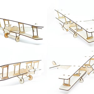May include: A wooden model airplane kit with four different views of the assembled model. The model is a biplane with a light wood finish.