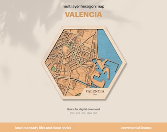 Può includere: Una mappa esagonale multistrato in legno di Valencia, Spagna. La mappa presenta un design dettagliato tagliato al laser con un layout della città marrone chiaro, una sezione d'acqua blu e il nome della città in oro. Il testo "VALENCIA" è ben visibile.