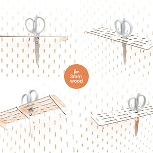 May include: Four wooden pegboard shelves with cutouts for holding tools. Each shelf has a pair of silver scissors hanging from it. The shelves are designed for 3mm thick wood.
