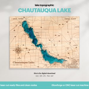 May include: A laser-cut wooden map of Chautauqua Lake in New York, USA. The lake is depicted in shades of blue, with surrounding roads and towns shown in brown. The map includes the latitude and longitude coordinates of the lake. The text "laser cut ready files and clean nodes" is at the bottom of the image.