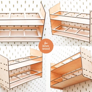 May include: Three different views of a wooden shelf unit designed for 3mm wood. The shelf unit has two shelves and three compartments on each shelf. The shelves are designed to be mounted on a pegboard wall.