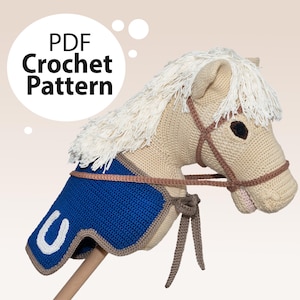 May include: Crochet pattern PDF for a beige and brown horse head with a blue saddle and a white letter U. The horse head is a toy for children.