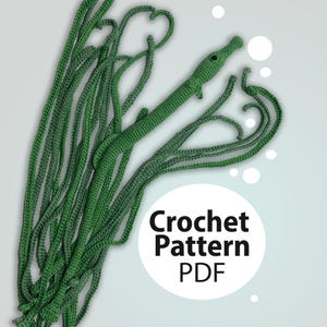 May include: A green crochet alligator with a long, textured body and a detailed head. The alligator is surrounded by long, green crochet strands. Text on the image reads "Crochet Pattern PDF".