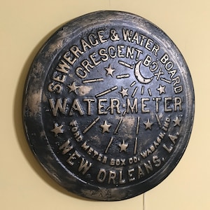 Unique wall art, famed, vintage New Orleans water meter cover