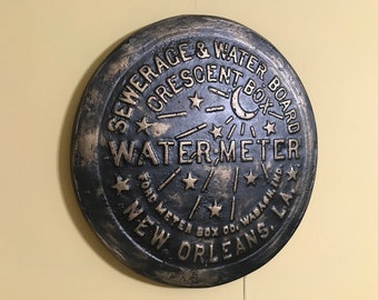 Unique wall art, famed, vintage New Orleans water meter cover