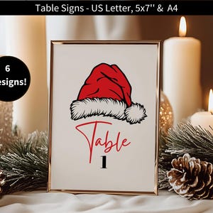 May include: A framed table sign with a red Santa hat design, the word "Table" in red script, and the number "1". The sign is surrounded by candles, pine needles, and ornaments. Text on the sign reads "Table Signs - US Letter, 5x7" & A4".
